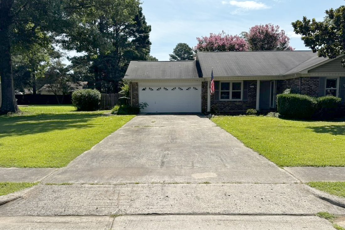 A driveway before pressure washing